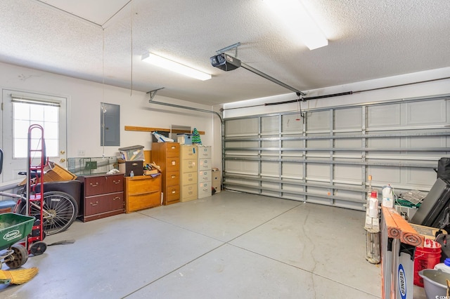 garage featuring electric panel and a garage door opener