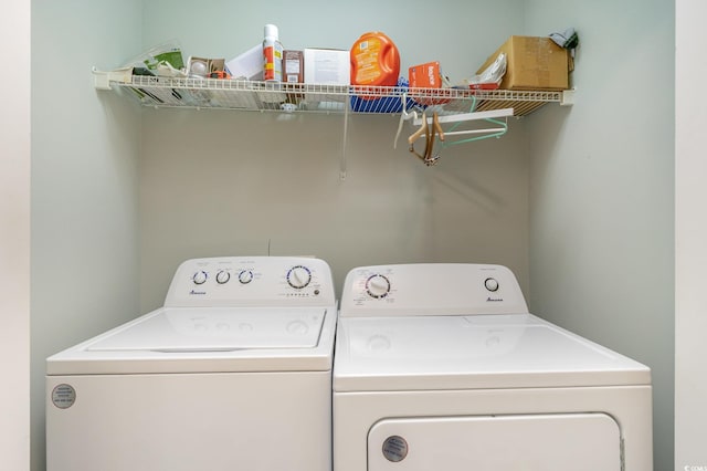 clothes washing area with washer and clothes dryer