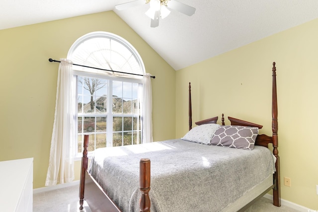 carpeted bedroom featuring ceiling fan and vaulted ceiling