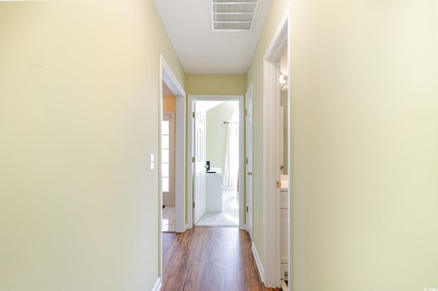 hallway with dark hardwood / wood-style floors