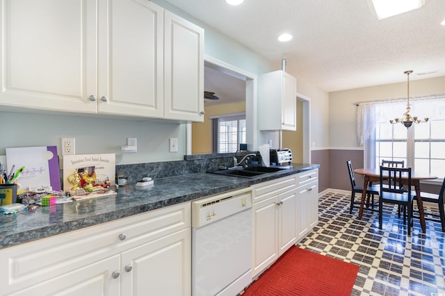 kitchen with sink, a textured ceiling, decorative light fixtures, white dishwasher, and white cabinets