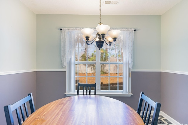 dining space featuring an inviting chandelier