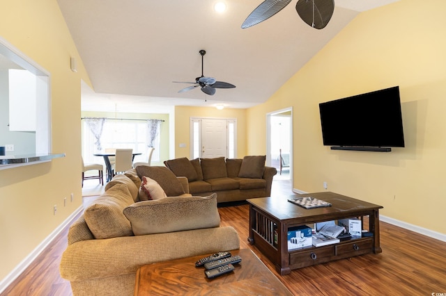 living room with hardwood / wood-style flooring, ceiling fan, and high vaulted ceiling