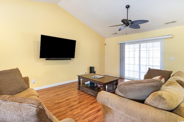 living room with hardwood / wood-style flooring, ceiling fan, and vaulted ceiling