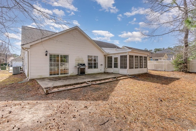 back of property with central AC unit, a patio, and a sunroom