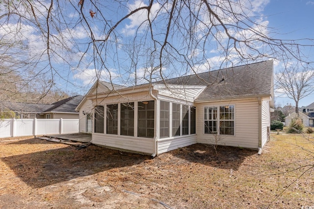 rear view of property featuring a sunroom