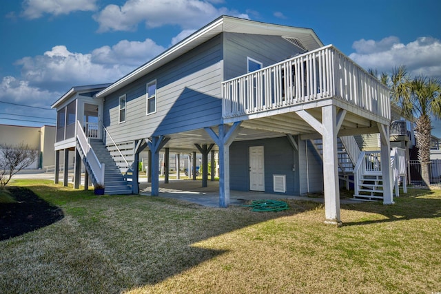 back of house with a yard, stairway, a wooden deck, and a patio