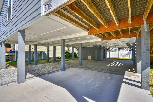 view of patio featuring fence and a carport