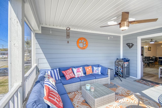 sunroom featuring ceiling fan and an outdoor hangout area