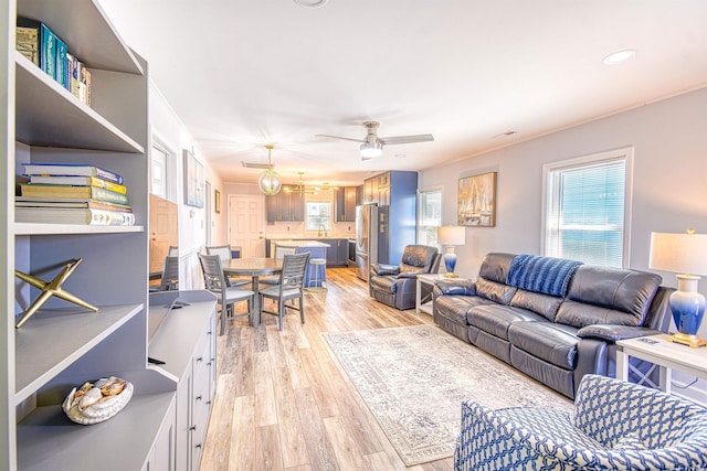 living area featuring a ceiling fan, recessed lighting, light wood-style flooring, and visible vents