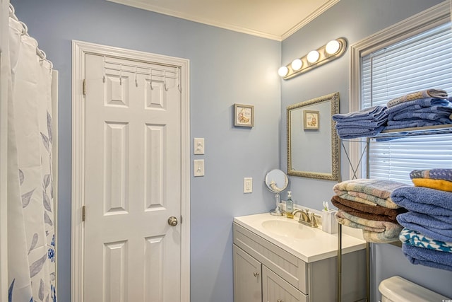 full bathroom with toilet, ornamental molding, and vanity