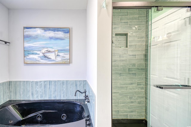 full bathroom with a tub with jets and a shower stall