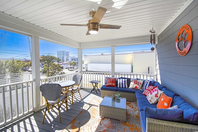 sunroom / solarium featuring a ceiling fan and an outdoor hangout area