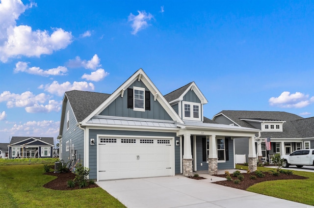 craftsman-style home featuring central air condition unit, a front yard, a garage, and a porch