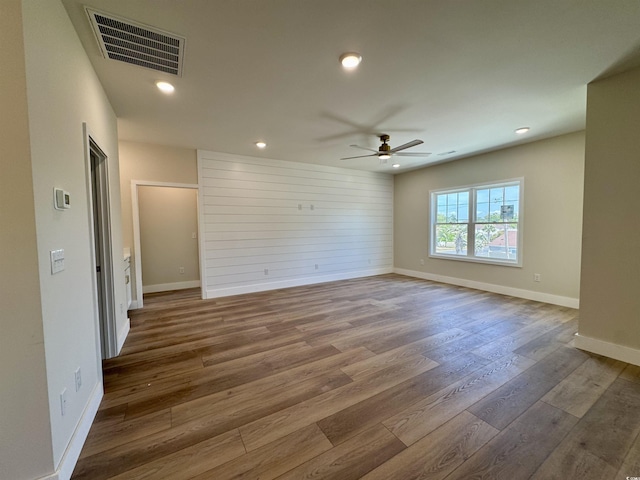 unfurnished room with a ceiling fan, visible vents, wood finished floors, and recessed lighting