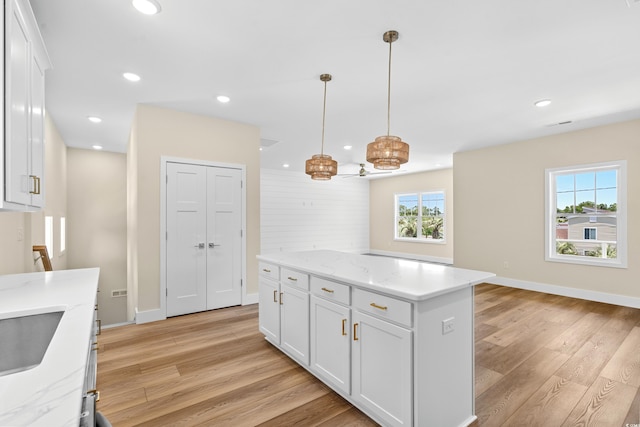 713 9th Ave S, North Myrtle Beach, SC 29582 - kitchen featuring light wood-style floors, white cabinetry, recessed lighting, a center island, and hanging light fixtures