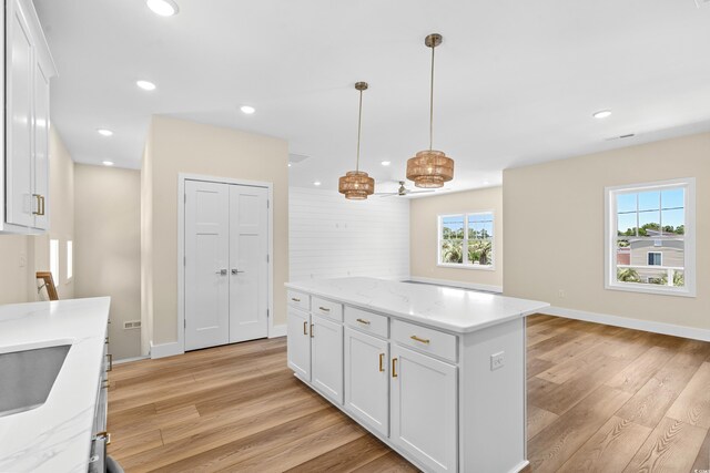 713 9th Ave S, North Myrtle Beach, SC 29582 - kitchen featuring light wood-style floors, white cabinetry, recessed lighting, a center island, and hanging light fixtures