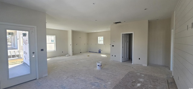 empty room featuring a baseboard heating unit and visible vents