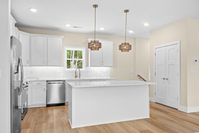 713 9th Ave S, North Myrtle Beach, SC 29582 - kitchen with stainless steel appliances, light wood-style floors, decorative backsplash, light countertops, and recessed lighting