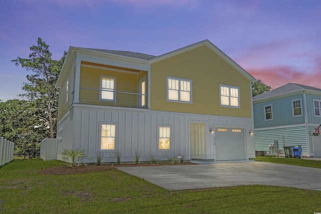 713 9th Ave S, North Myrtle Beach, SC 29582 - view of front facade featuring board and batten siding, a garage, driveway, and a front yard