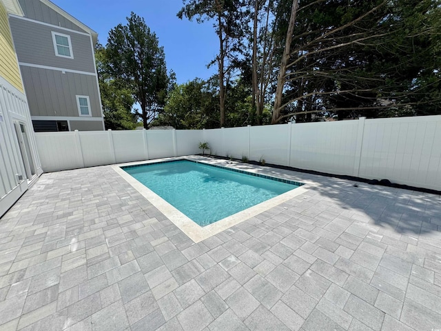 view of swimming pool with a fenced in pool, a fenced backyard, and a patio area