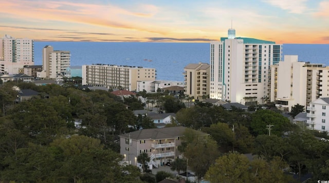 aerial view at dusk with a water view