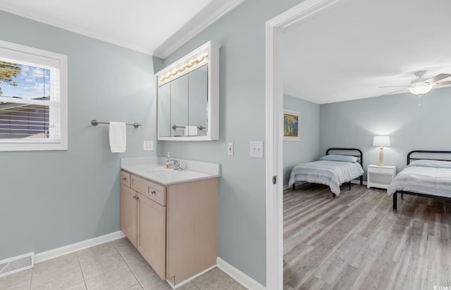 bathroom with hardwood / wood-style flooring, ceiling fan, and vanity