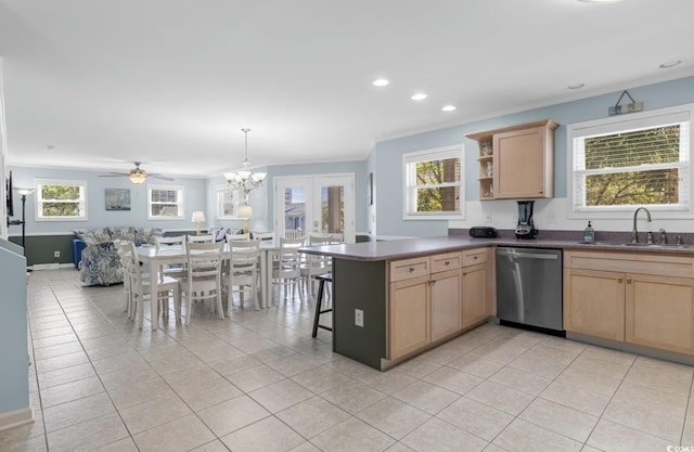 kitchen with kitchen peninsula, sink, stainless steel dishwasher, light tile patterned floors, and a kitchen bar