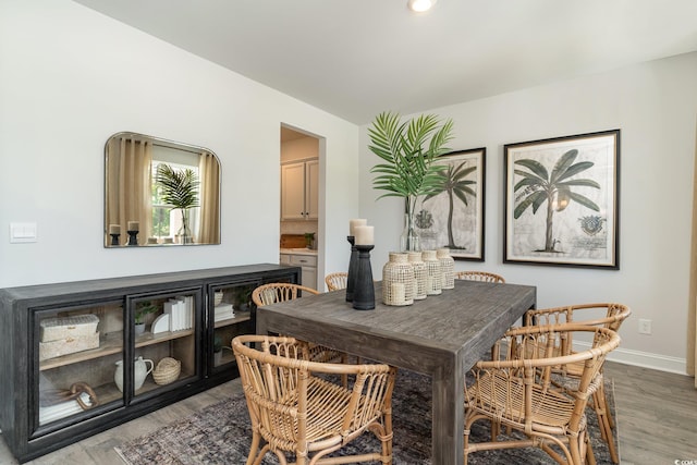 dining space with wood finished floors and baseboards