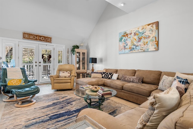 living area featuring high vaulted ceiling, wood finished floors, and french doors