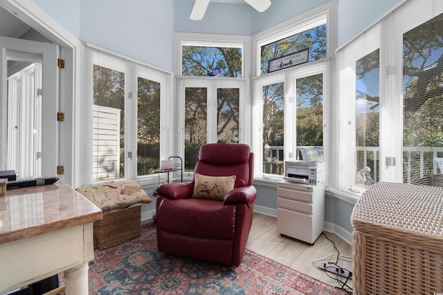 sunroom / solarium with a ceiling fan