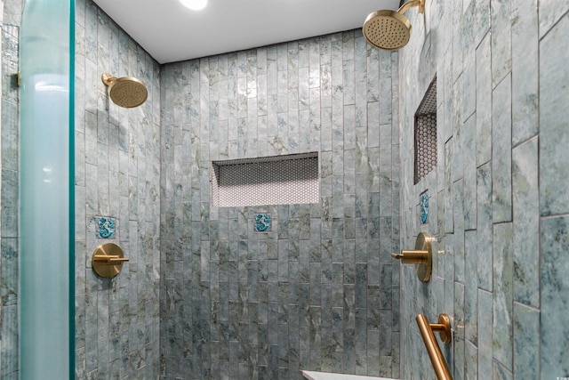 full bath featuring a tile shower