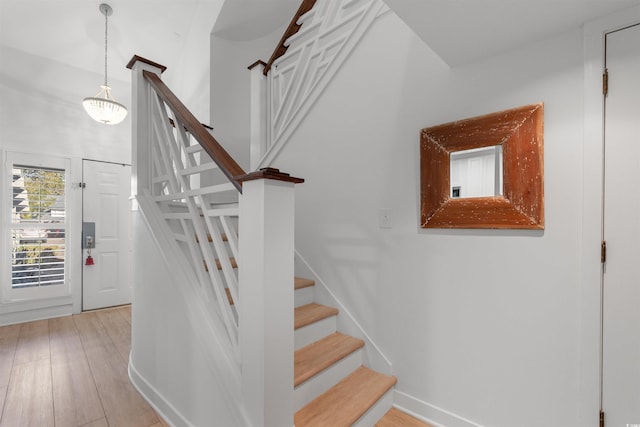 stairs featuring baseboards and wood finished floors