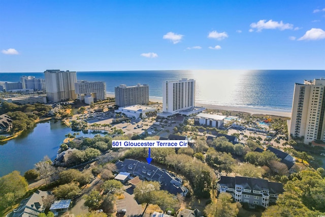 birds eye view of property featuring a water view and a city view