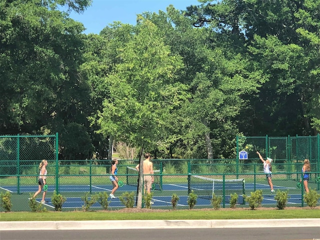 view of tennis court featuring fence