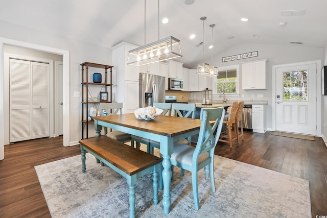 dining room with lofted ceiling, dark wood finished floors, visible vents, and baseboards