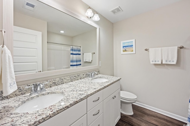 bathroom with a sink, visible vents, and baseboards