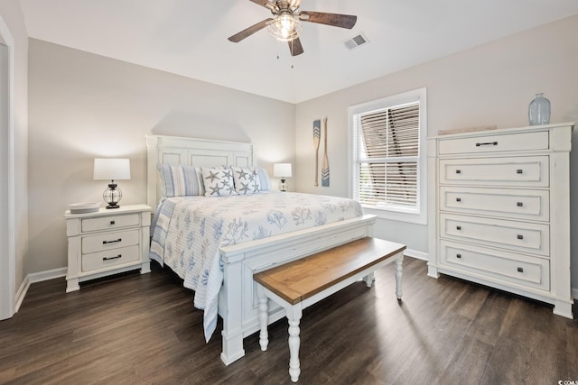 bedroom featuring dark wood finished floors, visible vents, and baseboards