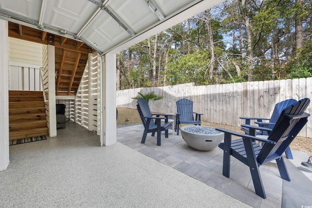 view of patio / terrace with a fire pit and a fenced backyard