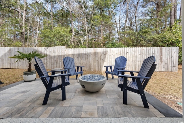 view of patio / terrace featuring a fenced backyard and a fire pit