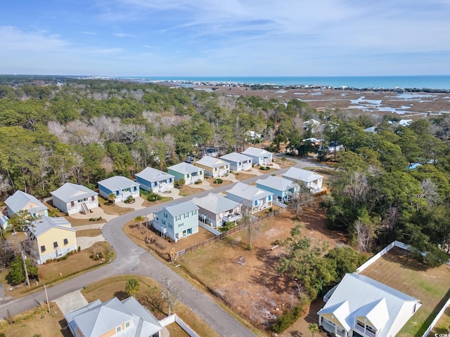 drone / aerial view featuring a residential view and a water view