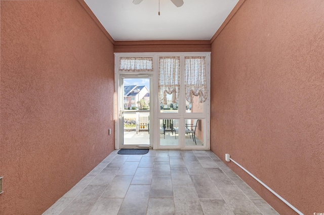 doorway to outside featuring ceiling fan and light tile patterned floors