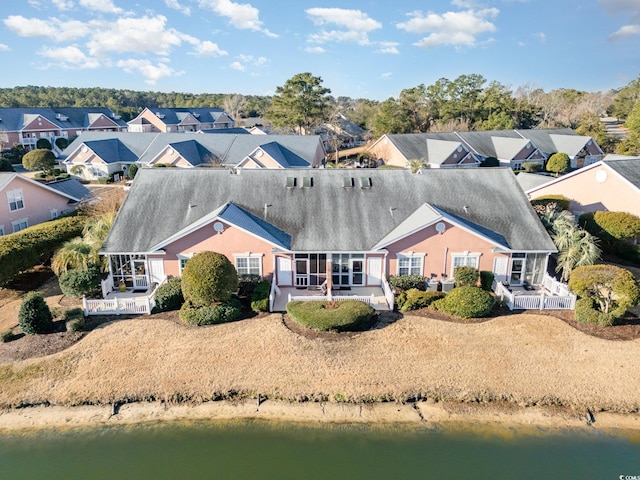 exterior space with a water view and a residential view