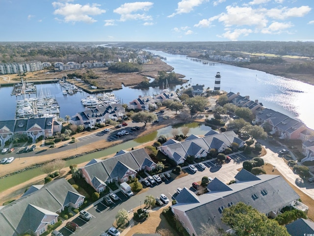 drone / aerial view with a water view and a residential view