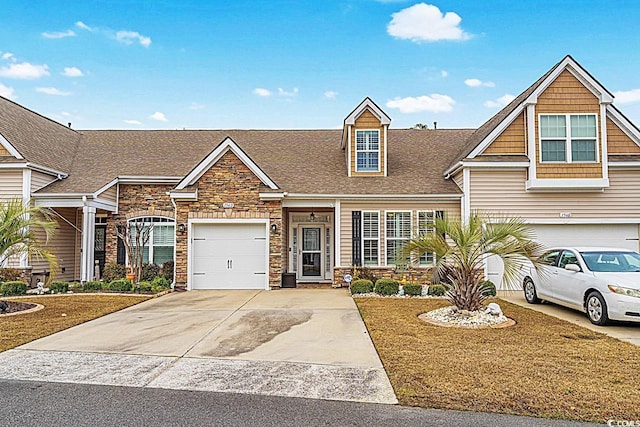 view of front of property with stone siding and driveway