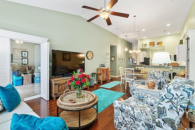 living room with dark wood finished floors, vaulted ceiling, ceiling fan with notable chandelier, and recessed lighting