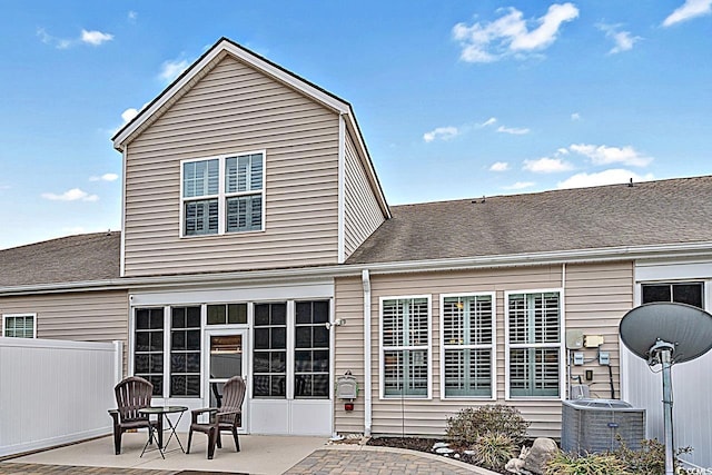 back of house with a patio area, central air condition unit, a shingled roof, and fence