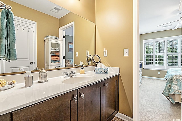 bathroom with visible vents, baseboards, ensuite bathroom, and vanity