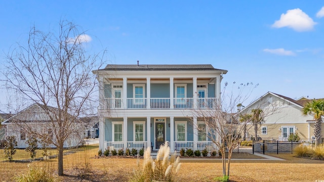 view of front of home featuring a porch, a front yard, and fence