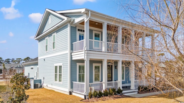 view of side of property featuring a porch and cooling unit